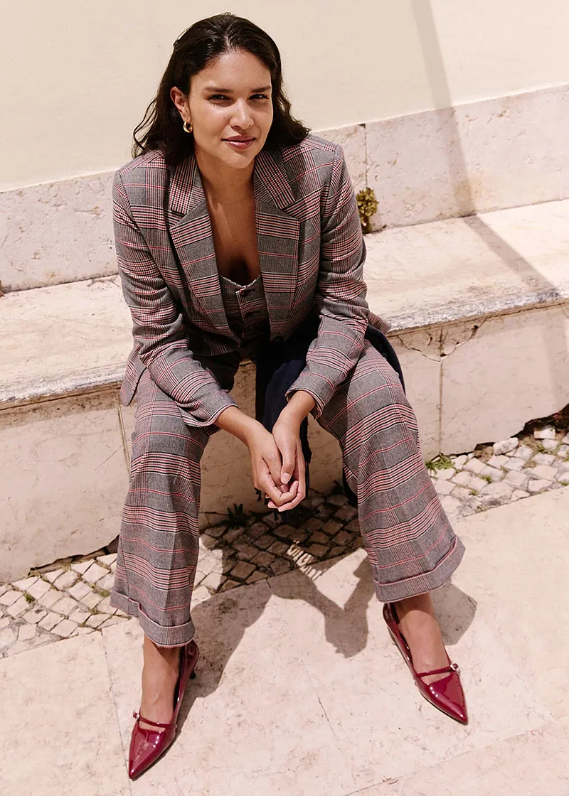 Blazer à carreaux et pantalon coordonné complété par une paire d'escarpins rouges.