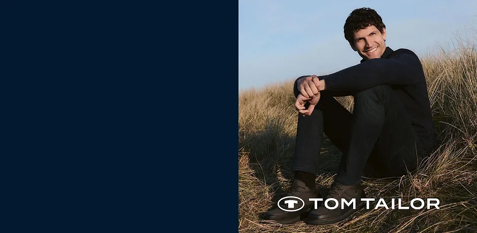 Pull noir et pantalon foncé : une tenue classique pour profiter d'une journée d'automne dans la nature.